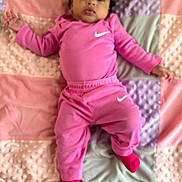 Nasya joined the competition — help win amazing prizes! baby, child, pink_clothing, nike_logo, blanket, pastel_colors, curly_hair, socks, infant, lying_down, soft_texture, cute, portrait, indoors, comfort, toddler, face, person, sleepwear, resting