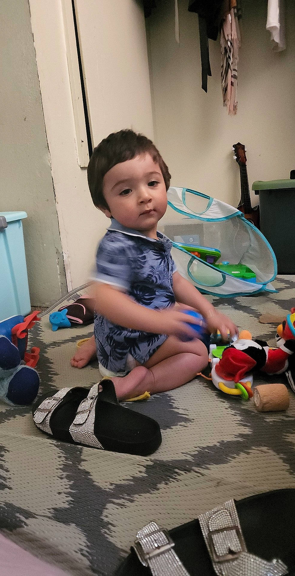 Abraham is registered to the contest to win money with this photo: baby, child, door, flooring, foot, fun, happy, human_leg, joint, knee, person, play, room, sandal, shorts, sitting, sneakers, sock, thigh, toddler