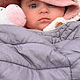 baby, child, hood, blanket, stuffed_animal, pink, gray, face, portrait, closeup, warm_clothing, cute, soft_toy, indoor, infant, person, cozy, winter, expressionless, bundle