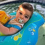 baby, blue, child, face, float, infant, inflatable_ring, outdoor, pacifier, person, play, pool, relaxation, starfish, summer, sunlight, water, water_toy, yellow, young_child