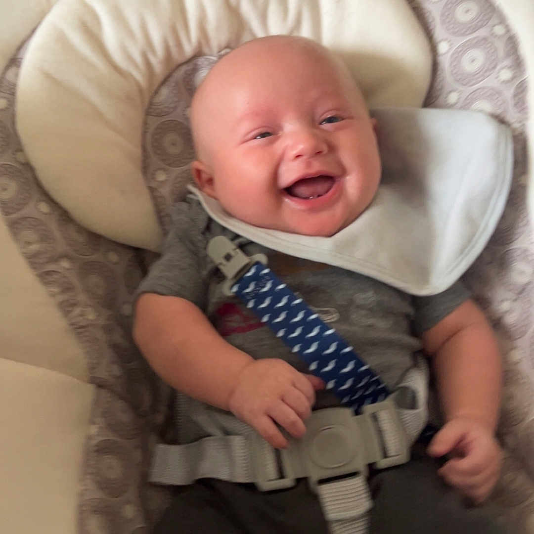 Dallas Ray Jr. joined the competition — help win amazing prizes! baby, baby_gear, bib, child, clothing, comfort, cushion, cute, happy, human, indoor, infant, person, portrait, relaxed, safety_strap, seat, seatbelt, smiling, young