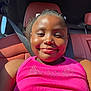 Londyn is registered to the contest to win money with this photo: child, smiling, car, seatbelt, pink_top, sunlight, happy, face, portrait, seated, interior, red_leather, dimples, casual, young, person, daylight, relaxed, closeup, vehicle
