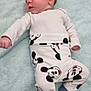 baby, blanket, blue_socks, child, clothing, cute, face, head, indoors, infant, lying_down, mickey_mouse, newborn, pajamas, person, resting, skin, sleepwear, small_hands, soft_texture