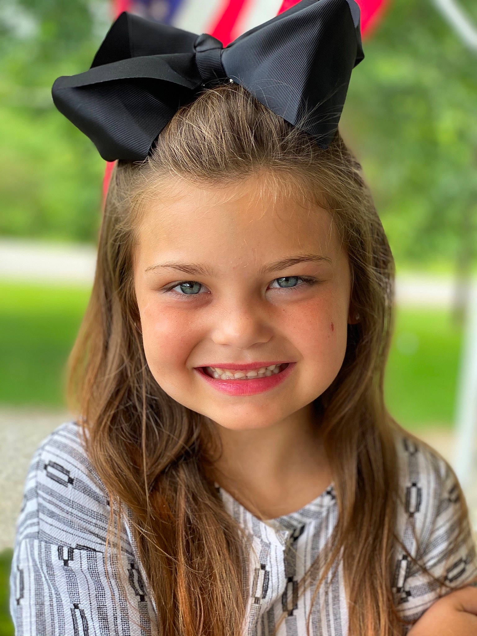 Adilyn is registered to the contest to win money with this photo: blond, brown_hair, child, clothing, costume_hat, electric_blue, eyebrow, fashion_accessory, fun, grass, hair_accessory, happy, headband, headpiece, joy, lip, long_hair, mortarboard, person, smile