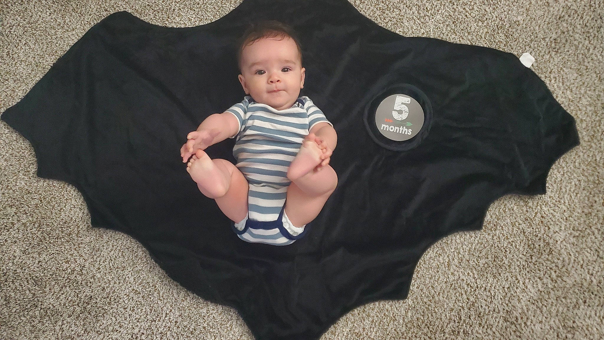 William joined the competition — help win amazing prizes! arm, baby, baby_products, baby_toddler_clothing, comfort, finger, flash_photography, gesture, grass, grey, hand, head, human_body, leg, pattern, person, sitting, sleeve, t_shirt, toddler