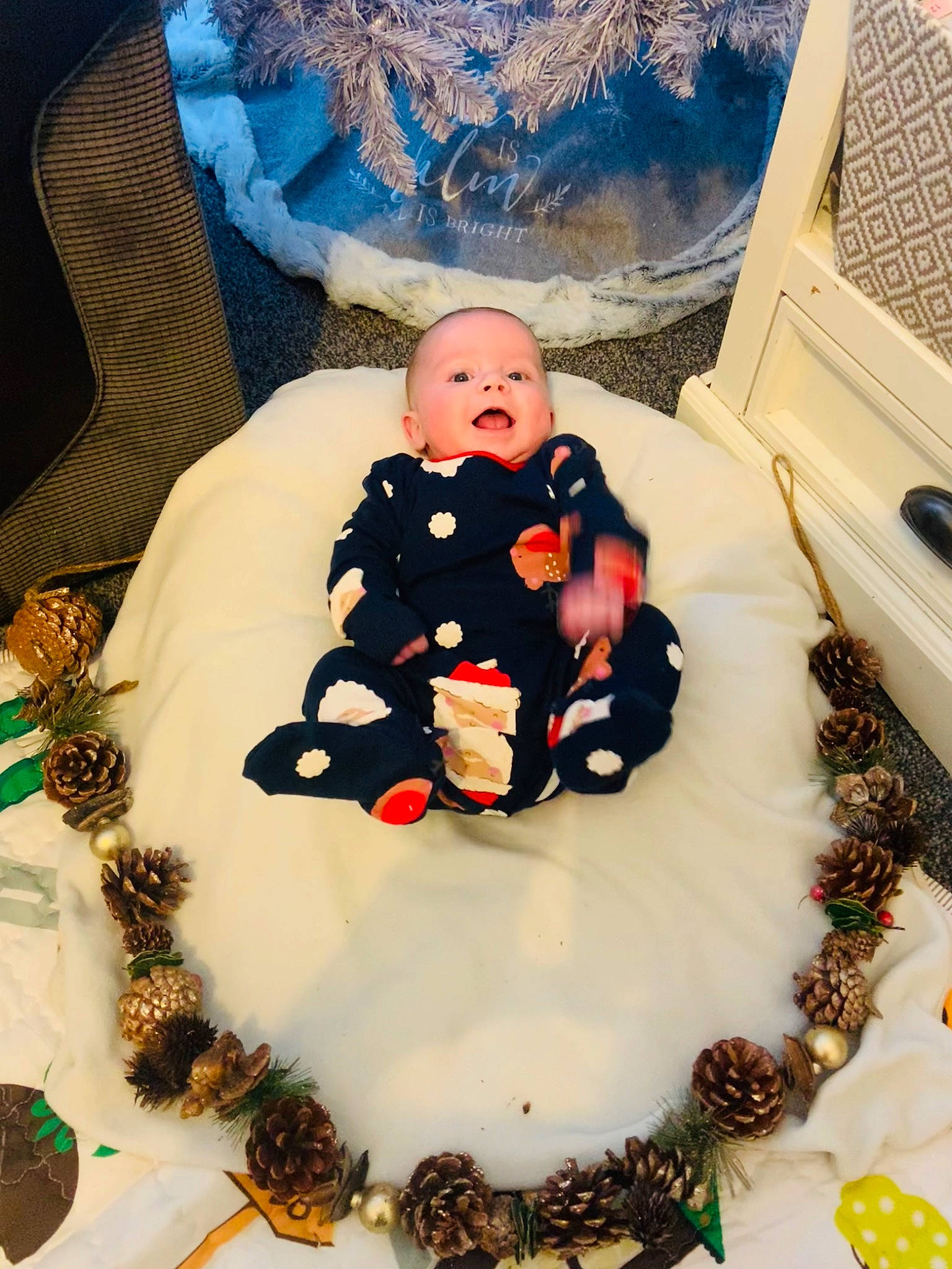 Toby is registered to the contest to win money with this photo: baby, baby_products, baby_toddler_clothing, blue, carmine, child, christmas, christmas_decoration, dessert, event, fictional_character, human_body, icing, pattern, person, room, sitting, sugar_cake, sweetness, toddler