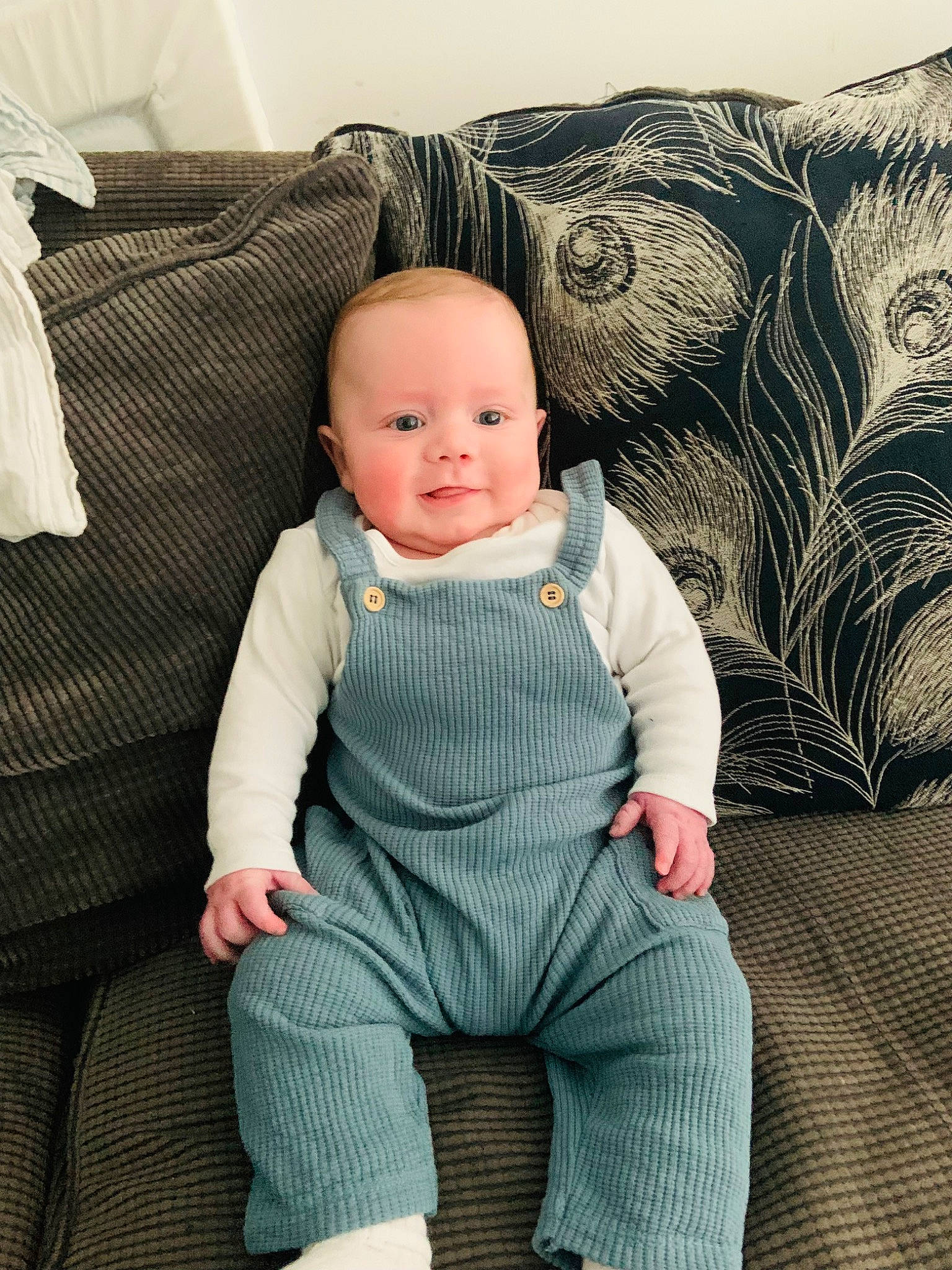 Toby joined the competition — help win amazing prizes! baby, baby_toddler_clothing, cheek, child, comfort, couch, eye, face, happy, head, human_body, linens, pattern, person, sitting, sleeve, smile, textile, throw_pillow, toddler