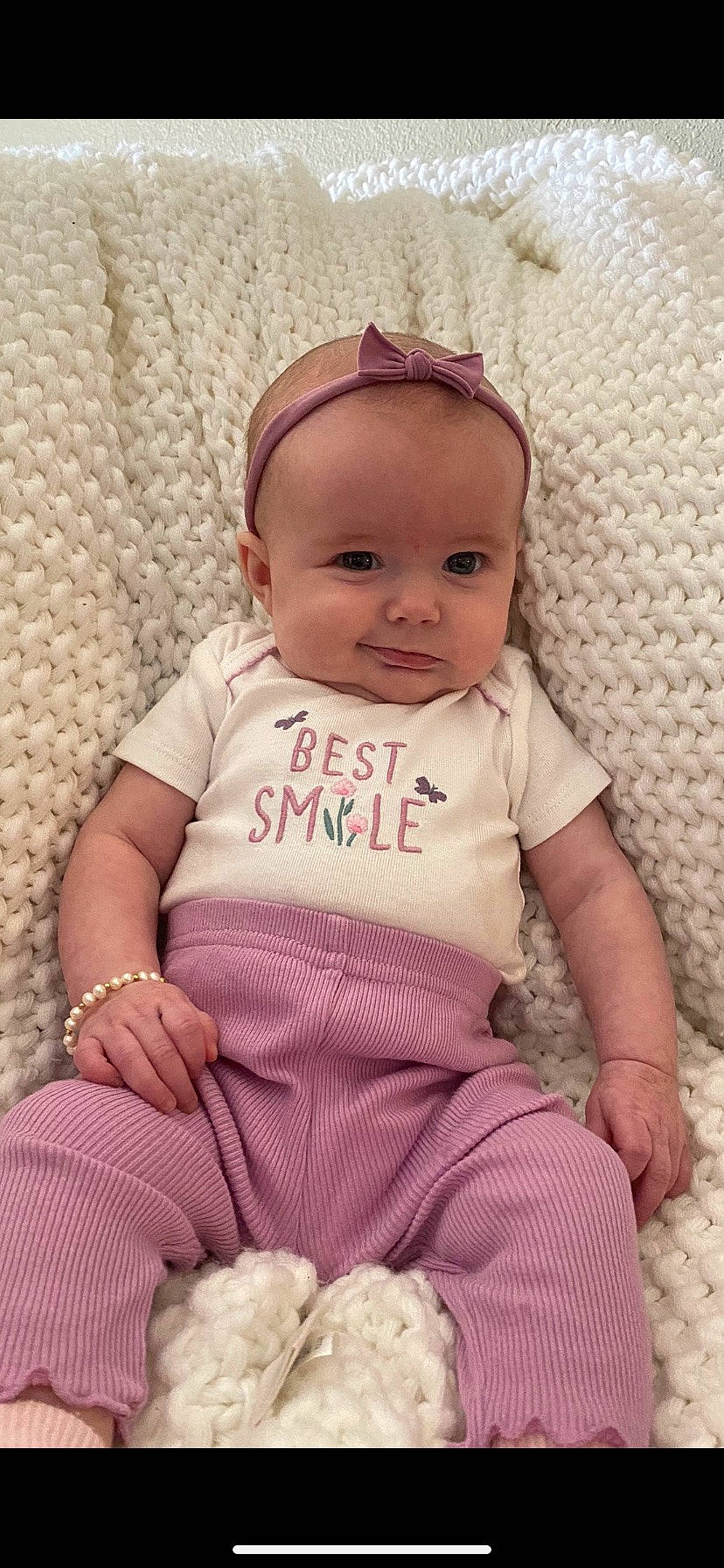 Maisie is registered to the contest to win money with this photo: baby, baby_toddler_clothing, cap, cheek, comfort, eye, happy, head, headgear, iris, linens, lip, magenta, pattern, person, pink, skin, sleeve, smile, textile