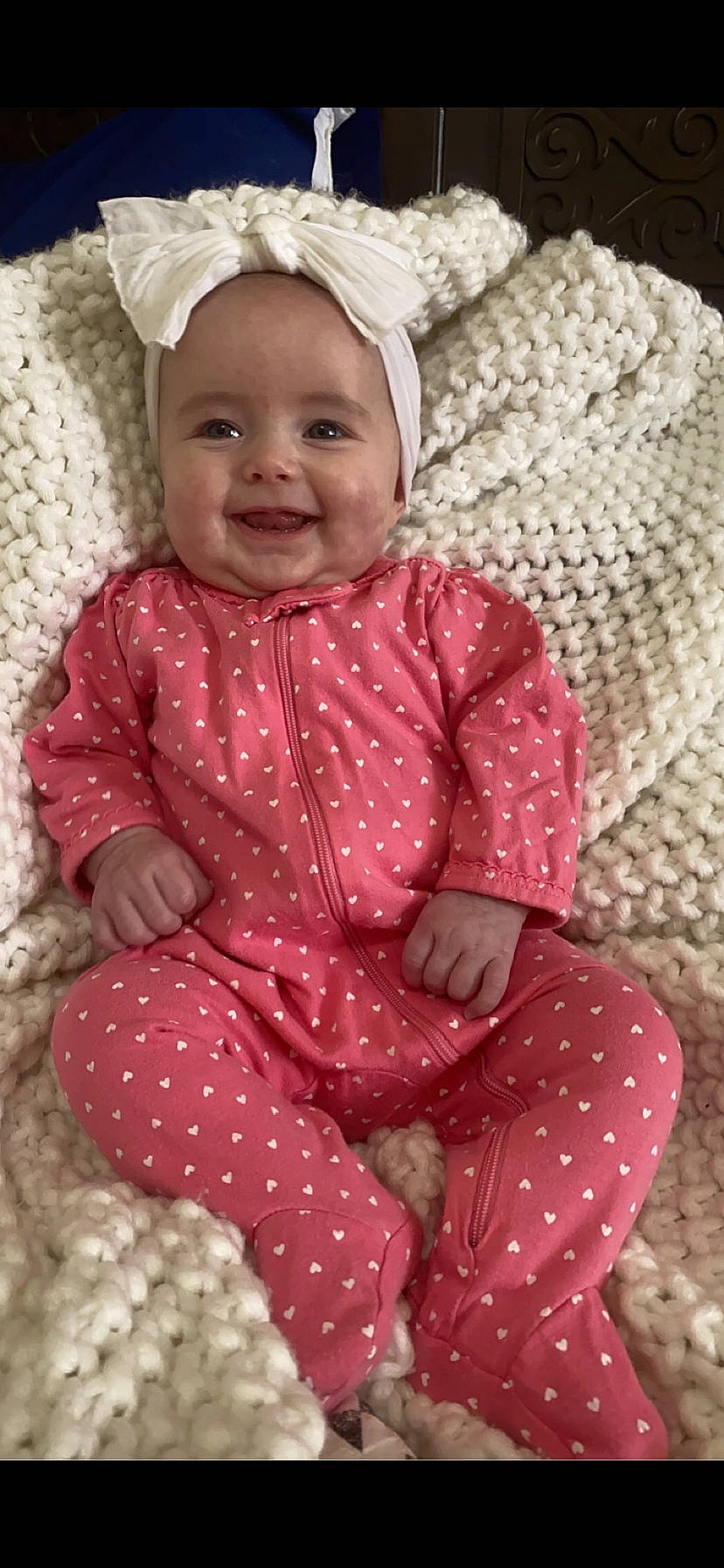 Maisie is registered to the contest to win money with this photo: arm, baby, baby_toddler_clothing, beauty, cap, cheek, dress, face, happy, head, headwear, joy, magenta, outerwear, pattern, people, person, pink, skin, sleeve