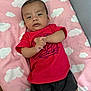 baby, child, infant, clothing, red_shirt, shorts, blanket, pink, cloud_pattern, lying_down, indoor, person, face, head, expression, hands, skin, young, cute, resting