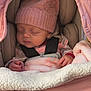 Aria is registered to the contest to win money with this photo: baby, sleeping, pink_hat, car_seat, blanket, pacifier, cozy, child, infant, cute, warm_clothing, soft_texture, toddler, face, headwear, resting, indoors, seatbelt, adorable, nap