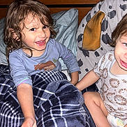 Matthiew joined the competition — help win amazing prizes! child, toddler, blanket, bed, pillow, smiling, clothing, plaid, hair, diaper, indoor, cute, happy, person, face, wood, animal_print, pattern, holding_hands, candid