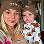 Noah joined the competition — help win amazing prizes! woman, baby, hat, knit_hat, matching_clothing, indoor, portrait, smile, child, person, cute, baby_clothing, animal_print, bear_print, blonde_hair, casual_clothing, home, artwork, door, ladder