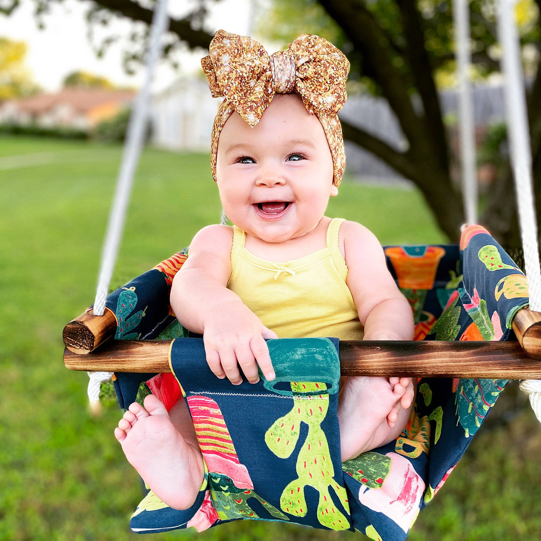 Erin joined the competition — help win amazing prizes! baby, baby_toddler_clothing, child, child_model, crown, ear, facial_expression, fun, hair_accessory, happy, headband, headgear, headwear, joy, outdoor_play_equipment, pattern, person, smile, summer, swing