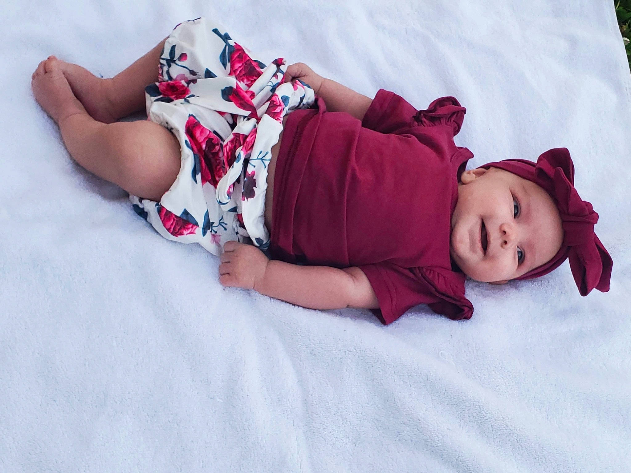 Freya is registered to the contest to win money with this photo: baby, baby_toddler_clothing, comfort, fun, happy, hat, headwear, human_body, human_leg, knee, leg, linens, magenta, pattern, person, pink, plant, purple, skin, textile