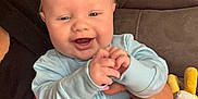 Tyde joined the competition — help win amazing prizes! baby, child, infant, smiling, happy, couch, toy, hand, adult, nail_polish, ring, onesie, indoor, person, face, blue_clothing, plush_toy, furniture, closeup, holding