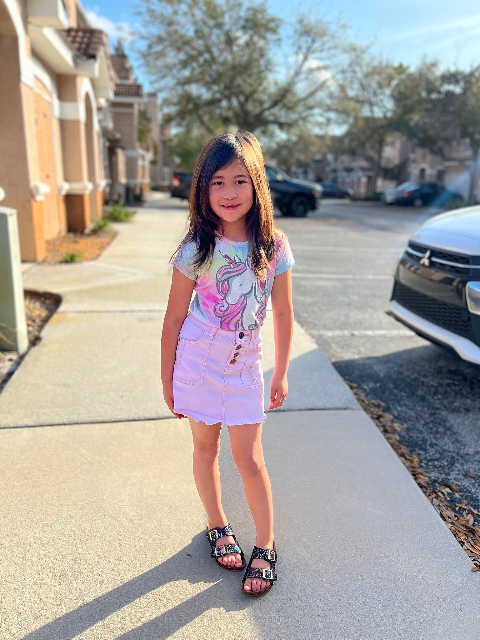 Lilyanna is registered to the contest to win money with this photo: asphalt, automotive_exterior, blond, bumper, car, denim, electric_blue, human_leg, infrastructure, joy, motor_vehicle, pedestrian, person, personal_luxury_car, recreation, road, sky, summer, thigh, tree