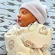 Robert joined the competition — help win amazing prizes! baby, newborn, sleeping, hat, onesie, lion_pattern, blanket, arrows, cozy, infant, peaceful, cute, face, child, portrait, soft, resting, clothing, sleep, toddler