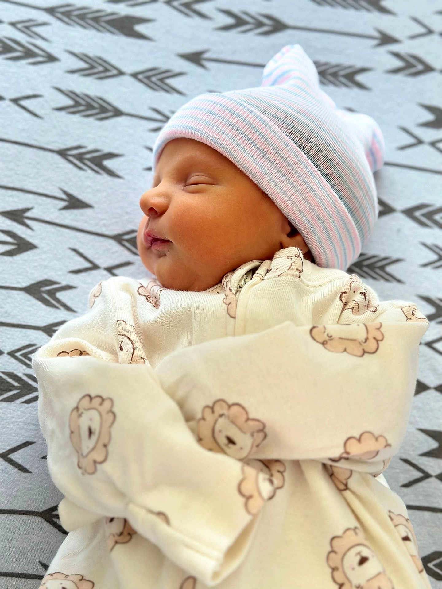 Robert joined the competition — help win amazing prizes! baby, newborn, sleeping, hat, onesie, lion_pattern, blanket, arrows, cozy, infant, peaceful, cute, face, child, portrait, soft, resting, clothing, sleep, toddler