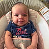 Seylah is registered to the contest to win money with this photo: baby, infant, smiling, blue_shirt, love_text, unicorn, baby_seat, cushion, pink, comfortable, happy, cute, portrait, child, indoors, soft_toys, face, hand, clothing, head
