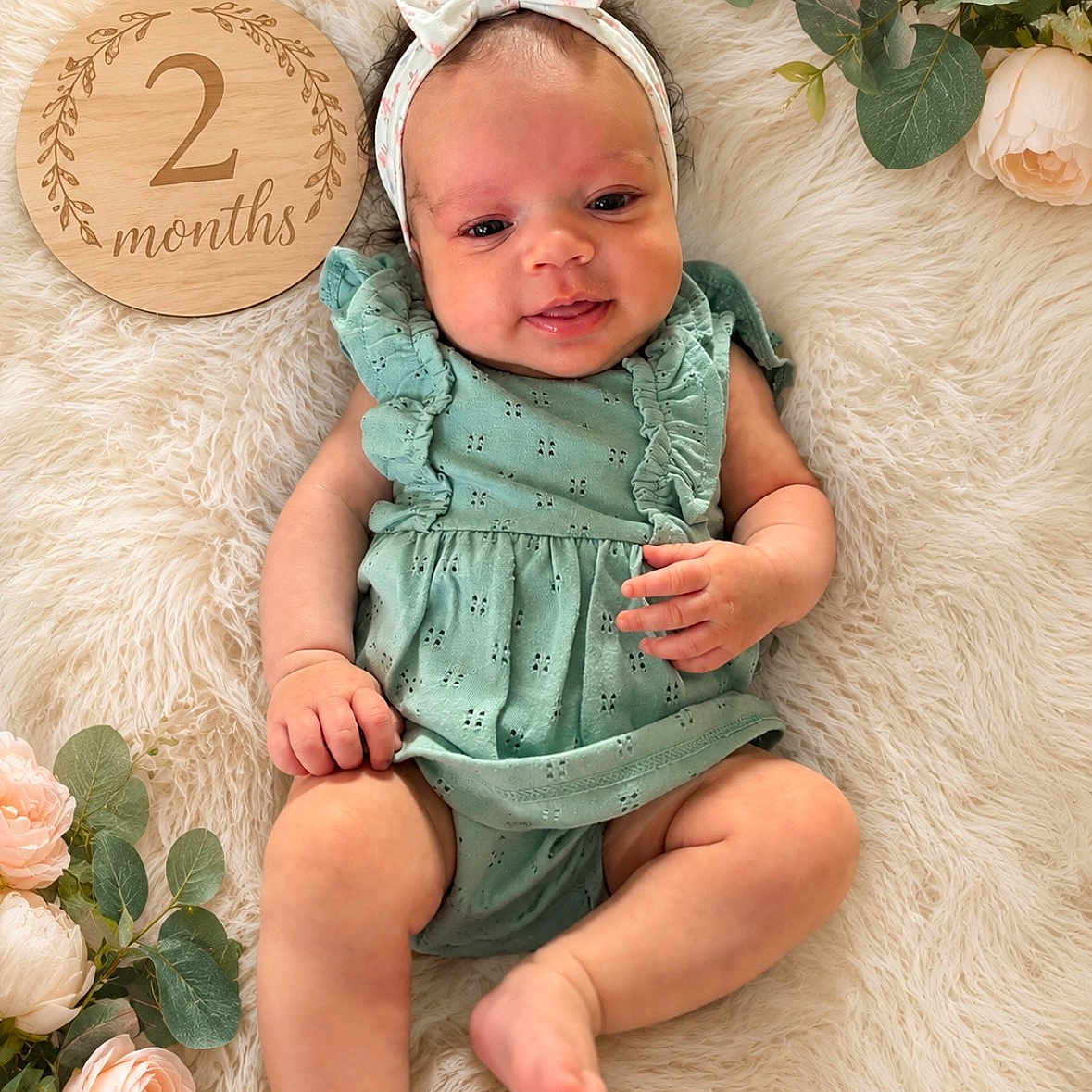 Seylah joined the competition — help win amazing prizes! 2_months, baby, baby_girl, cute, decor, flowers, fluffy_rug, green_outfit, headband, infant, lying_down, natural_light, newborn, portrait, roses, ruffles, skin, smile, soft_texture, wooden_sign
