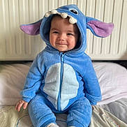 Emilio a rejoint le concours — aidez-le/la à gagner de superbes lots ! baby, infant, child, blue_costume, onesie, hood, ears, smile, sitting, socks, bed, pillow, blanket, radiator, cozy, cute, portrait, face, zipper, soft_fabric