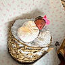 newborn, baby, sleeping, swaddle, pink_bow, basket, fluffy_blanket, patterned_background, butterflies, headband, infant, cozy, nursery, woven_basket, soft_texture, resting, portrait, cute, indoor, peaceful