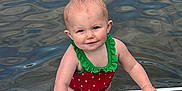 Westyn is registered to the contest to win money with this photo: toddler, child, water, paddleboard, swimsuit, red, green, outdoor, summer, play, baby, water_sport, fun, lake, person, smile, wet_hair, cute, recreation, nature