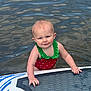 toddler, child, water, paddleboard, swimsuit, red, green, outdoor, summer, play, baby, water_sport, fun, lake, person, smile, wet_hair, cute, recreation, nature