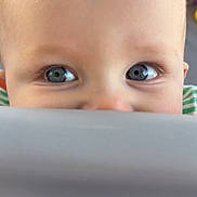 Westyn joined the competition — help win amazing prizes! baby, child, face, eyes, blue_eyes, bald_head, peek, curious, close_up, infant, skin, expression, cute, portrait, indoor, soft_light, fabric, playful, person, head