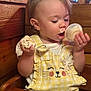 Paisley joined the competition — help win amazing prizes! baby, child, clothing, cream, cute, eating, face, food, hand, happy, high_chair, ice_cream, indoor, messy, portrait, seat, table, toddler, wood_paneling, yellow_overalls