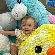 Paisley joined the competition — help win amazing prizes! blue_bear, bright_colors, child, child_clothing, cute, face, happy, indoor, joyful, person, playtime, plush_toy, seated, short_sleeves, smile, soft_texture, stuffed_animal, toddler, toy_collection, yellow_chick
