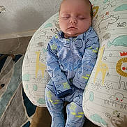 Rhyker joined the competition — help win amazing prizes! baby, sleeping, onesie, blue, shark_pattern, pillow, animal_print, giraffe, elephant, lion, sloth, couch, carpet, indoor, child, infant, cute, peaceful, resting, cozy