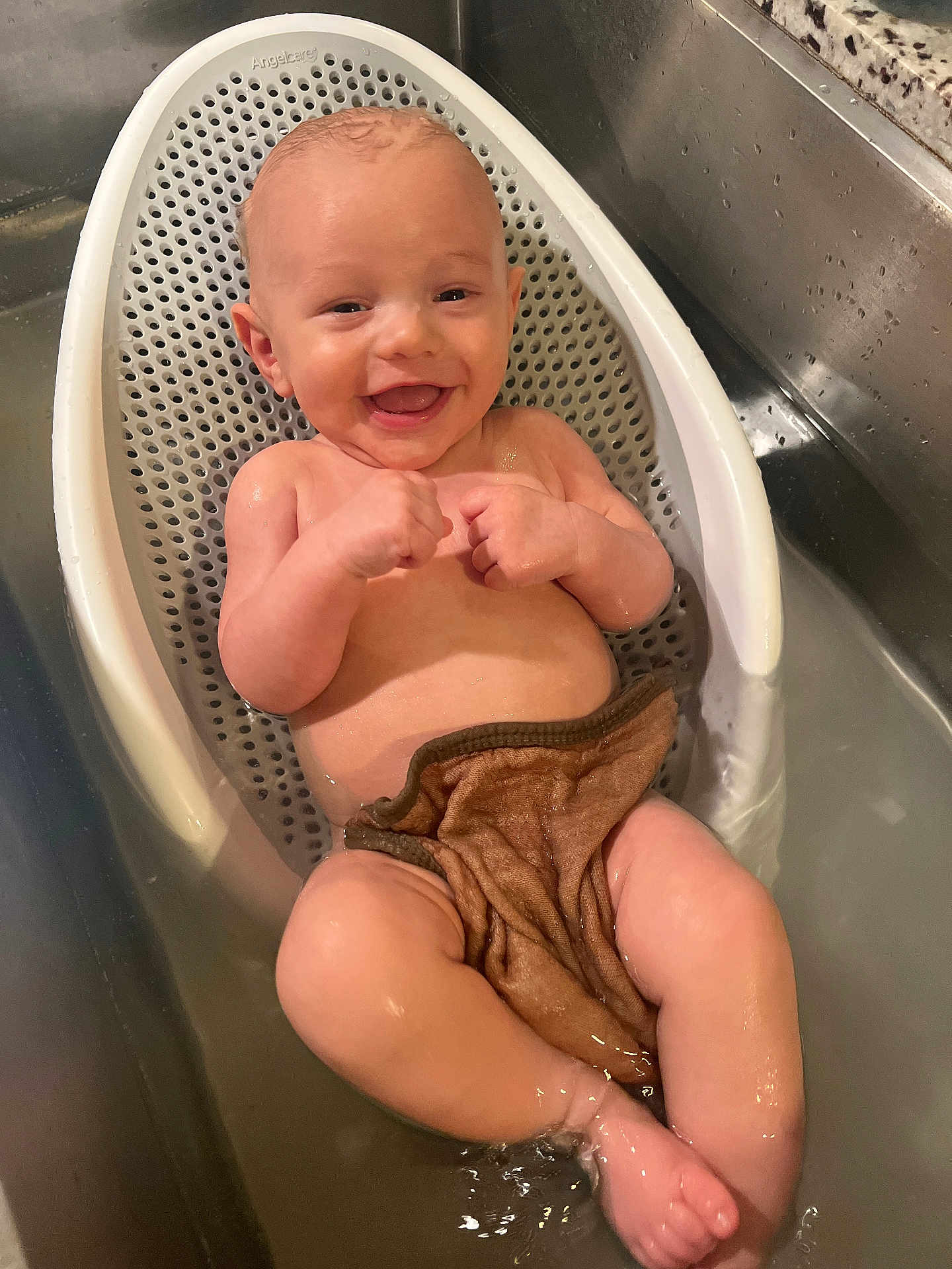 Stetson is registered to the contest to win money with this photo: baby, bath, water, sink, smile, happy, infant, child, bathseat, washcloth, skin, playful, cute, relaxing, indoors, toddler, person, bathtime, clean, young