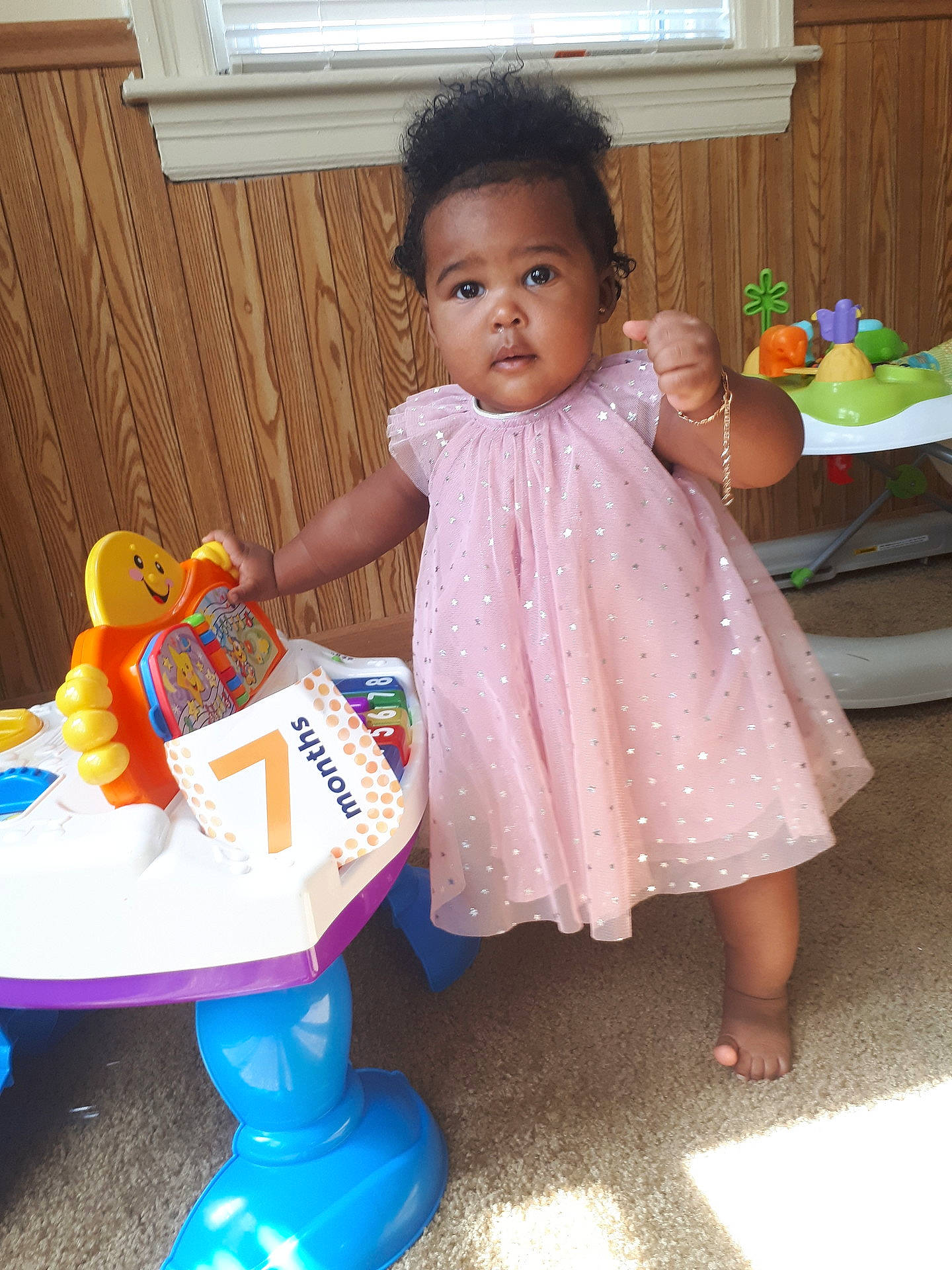 Karlee is registered to the contest to win money with this photo: child, day, fun, girl, infant, iris, person, pink, play, product, skin, smile, standing, textile, toddler, toy