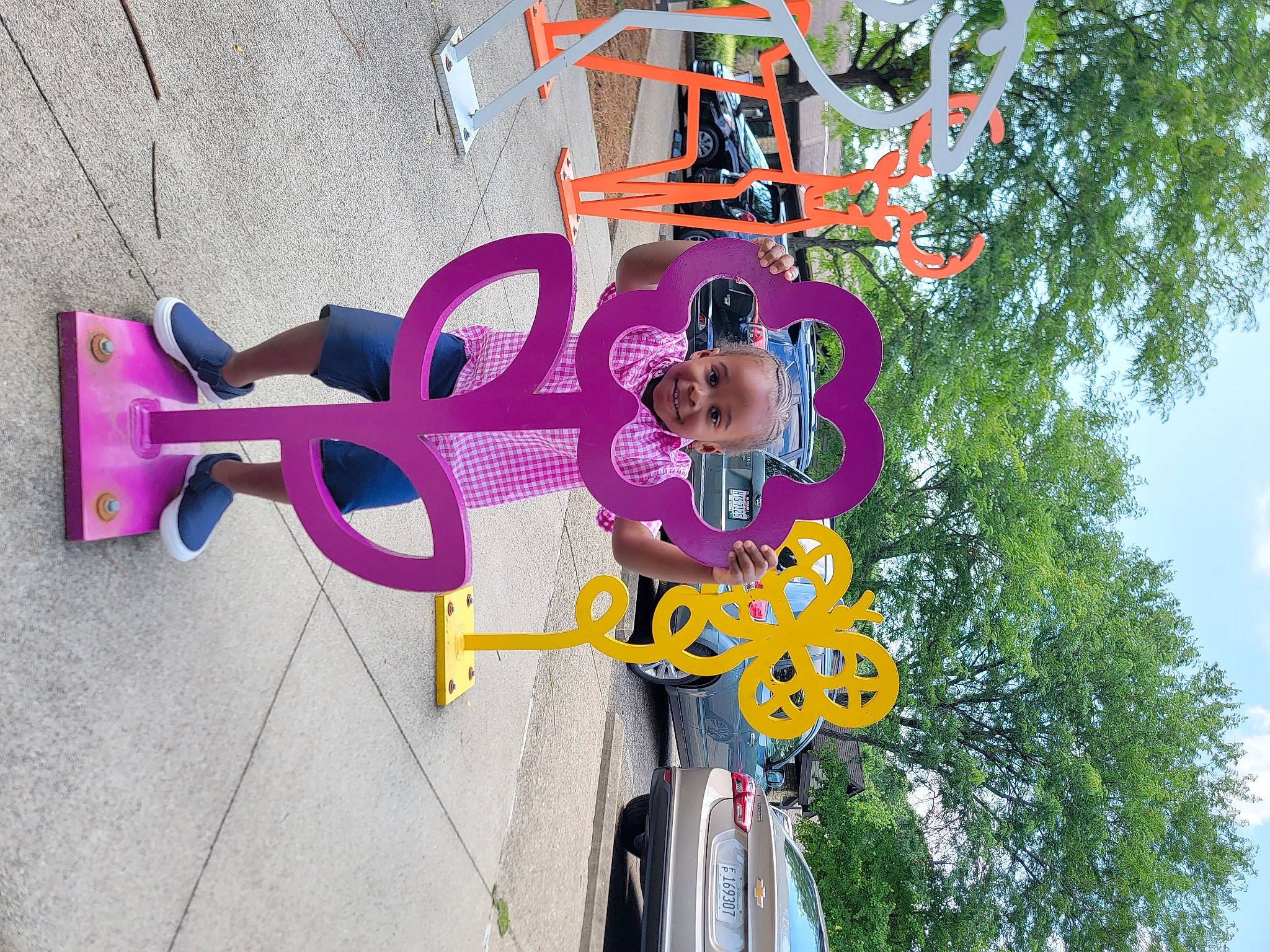 Kendall is registered to the contest to win money with this photo: automotive_wheel_system, bicycle_handlebar, bicycle_tire, bicycle_wheel, cloud, electric_blue, fun, hat, joy, leisure, magenta, person, plant, pole, purple, recreation, signage, sky, sunglasses, tire