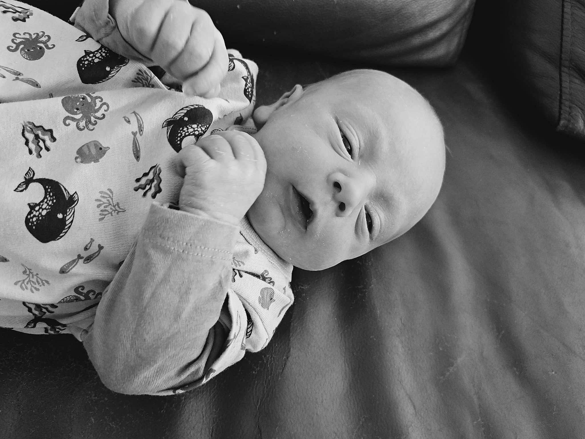 Matt participe au concours pour gagner de l'argent avec cette photo : arm, baby_toddler_clothing, black, black_and_white, cheek, comfort, drinkware, flash_photography, gesture, hand, happy, iris, mouth, nose, person, skin, sleeve, smile, style, toddler