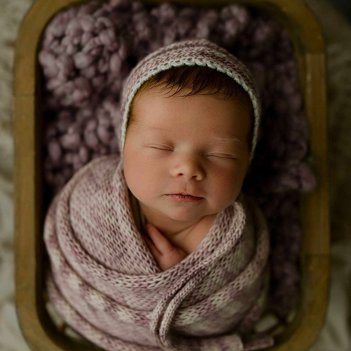 Ember is registered to the contest to win money with this photo: newborn, baby, sleeping, swaddled, blanket, knitted, hat, basket, purple, cozy, portrait, peaceful, infant, cute, soft, resting, closeup, indoors, warm, babyphotography