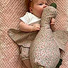 Ember joined the competition — help win amazing prizes! baby, bow, plush_toy, duck, blanket, pink, clothing, infant, cute, toddler, soft_texture, hand, feet, face, lying_down, toy, pattern, child, comfort, nibble