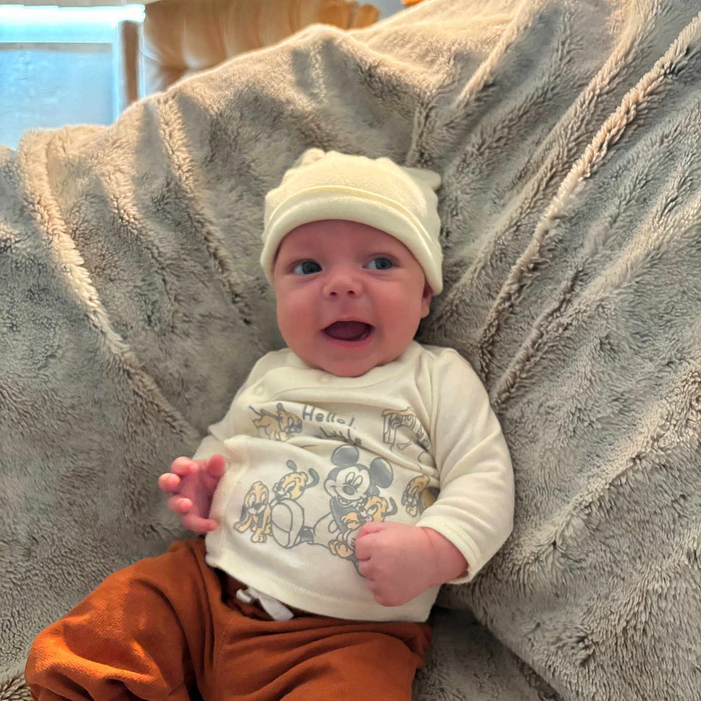 Silas is registered to the contest to win money with this photo: baby, bed, blanket, bodypart, bonnet, cap, clothing, couch, face, finger, furniture, hand, hat, head, newborn, pants, person, photography, portrait, t_shirt