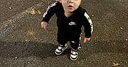 Kylo joined the competition — help win amazing prizes! asphalt, autumn, black_clothing, casual_wear, child, curious, footwear, leaves, looking_up, night, nike, outdoor, person, sidewalk, small_person, sneakers, street, toddler, urban, young_child