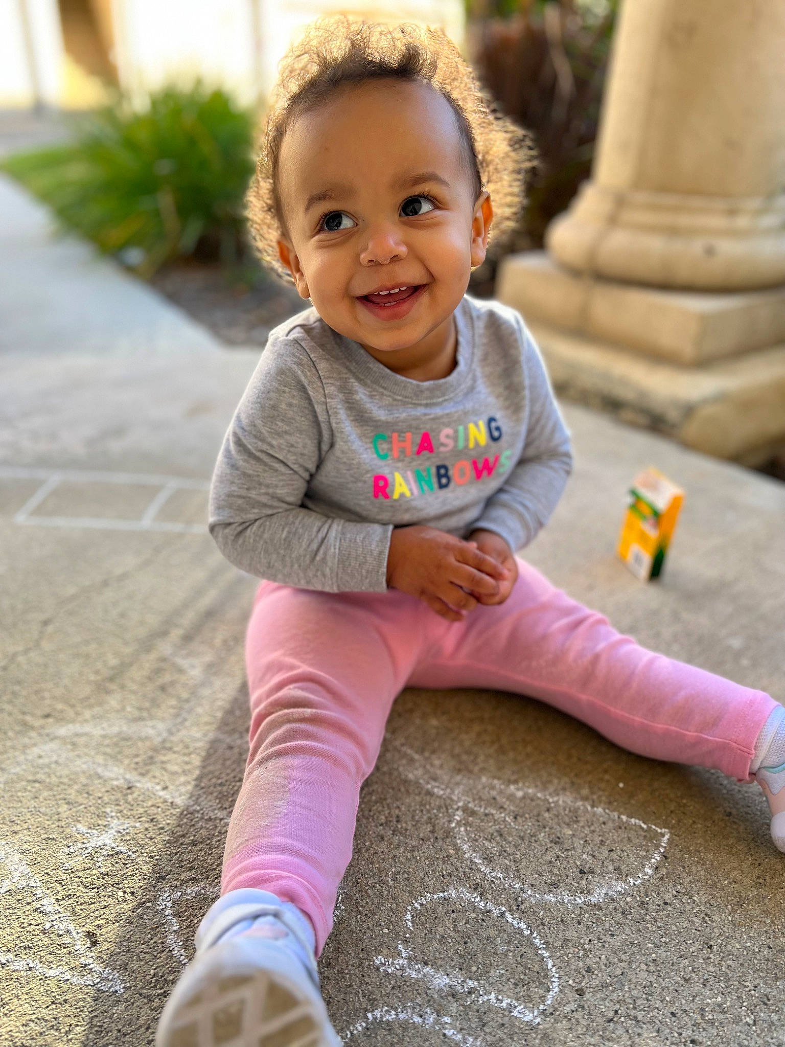 Alaia is registered to the contest to win money with this photo: baby, baby_toddler_clothing, cheek, child, face, flooring, fun, grass, happy, joy, magenta, pattern, person, pink, sitting, skin, sleeve, smile, sock, t_shirt