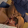 mother, newborn, baby, hospital, blanket, headwrap, medical_tape, nasal_tube, skin_to_skin, love, care, woman, infant, holding, portrait, closeup, family, healthcare, tenderness, indoor
