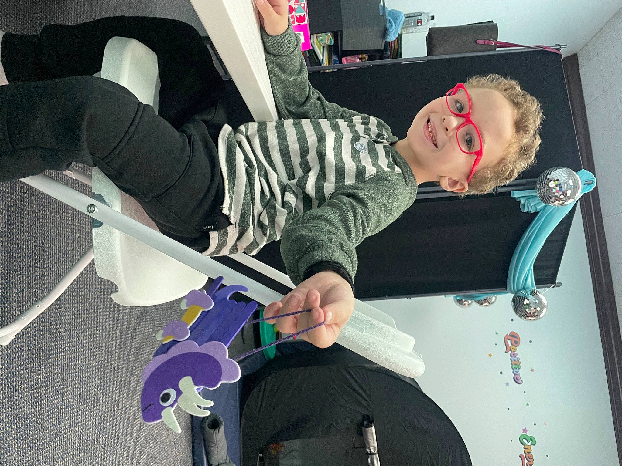 Zachary is registered to the contest to win money with this photo: auto_part, automotive_design, chair, comfort, eyewear, fictional_character, fun, human_leg, joy, knee, leisure, person, recreation, room, sitting, sportswear, thigh, vehicle_door