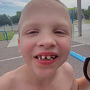 Jasper joined the competition — help win amazing prizes! child, smiling, wet, outdoor, playground, splash_pad, summer, bare_chest, teeth, face, happy, water_drops, skin, short_hair, park, daylight, recreation, fun, person, closeup