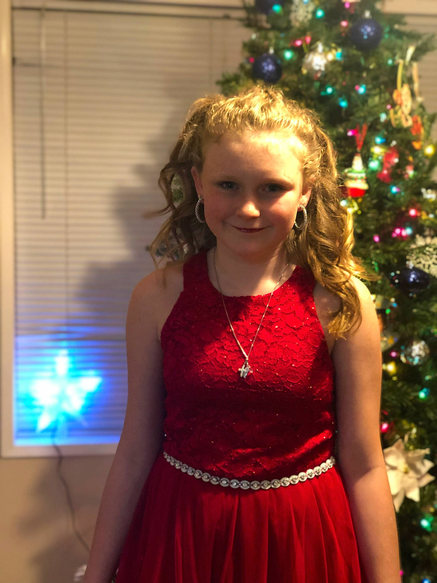 Regan is registered to the contest to win money with this photo: blond, child, child_model, christmas, christmas_decoration, christmas_eve, christmas_ornament, christmas_tree, cocktail_dress, dress, event, formal_wear, hair, holiday, interior_design, long_hair, person, smile, tree