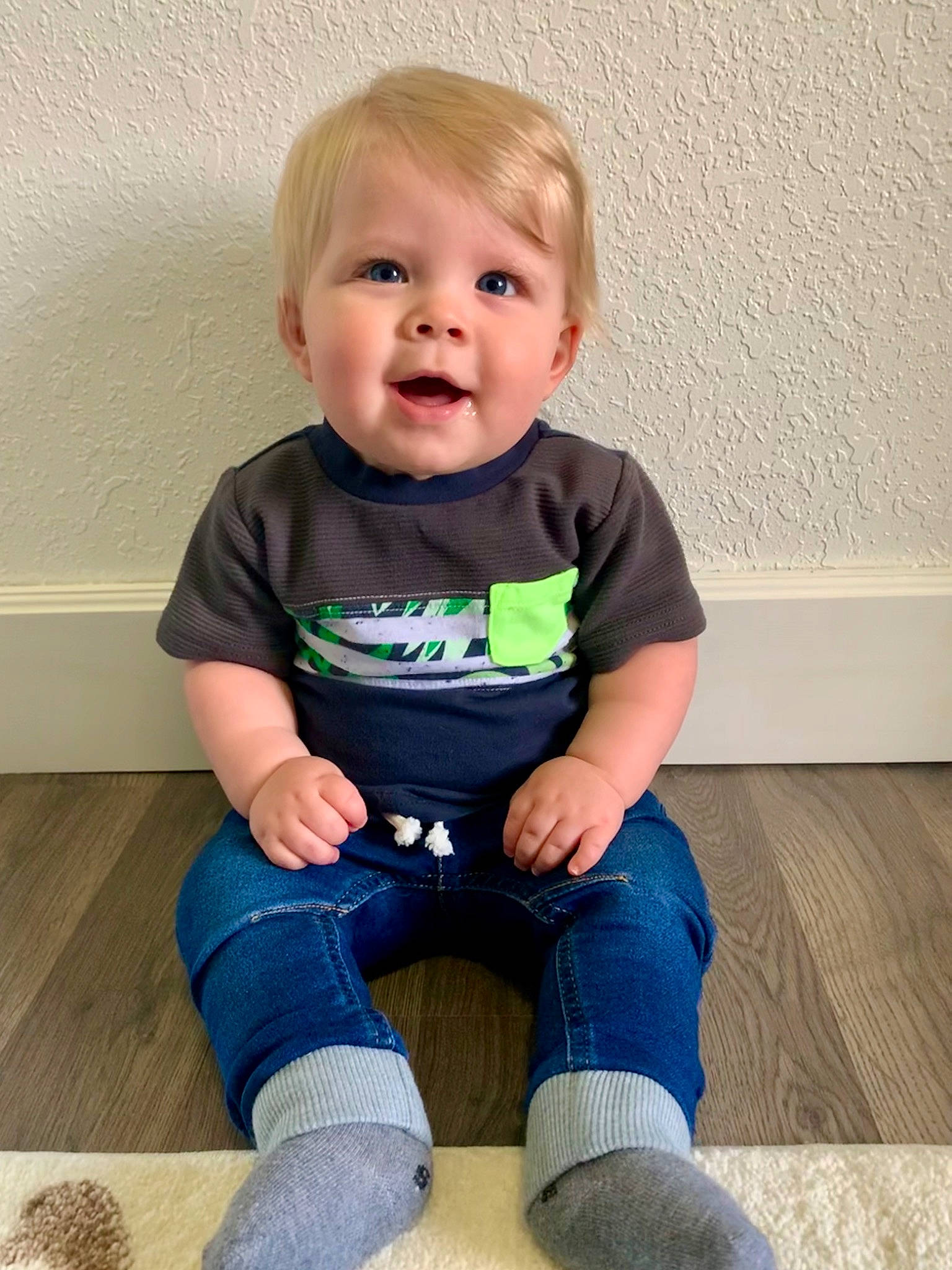 Brayson is registered to the contest to win money with this photo: baby, baby_toddler_clothing, cheek, clothing, electric_blue, face, flooring, hair, happy, head, jeans, joint, knee, person, skin, sleeve, smile, sportswear, t_shirt, thigh