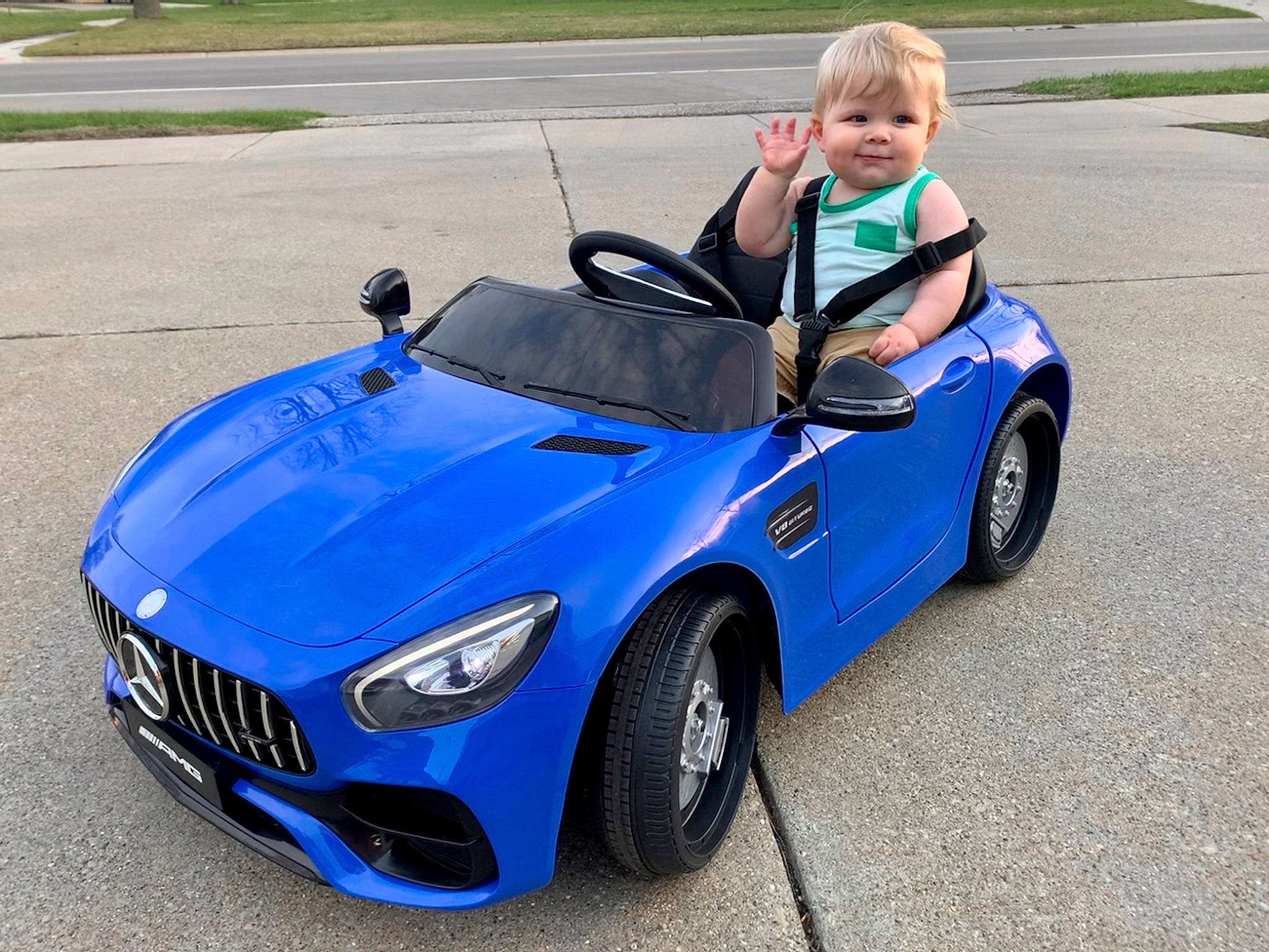 Brayson is registered to the contest to win money with this photo: alloy_wheel, automotive_design, automotive_exterior, automotive_fog_light, automotive_lighting, automotive_wheel_system, car, electric_blue, fender, grille, hood, joy, motor_vehicle, person, personal_luxury_car, plant, rim, tire, toddler, vehicle