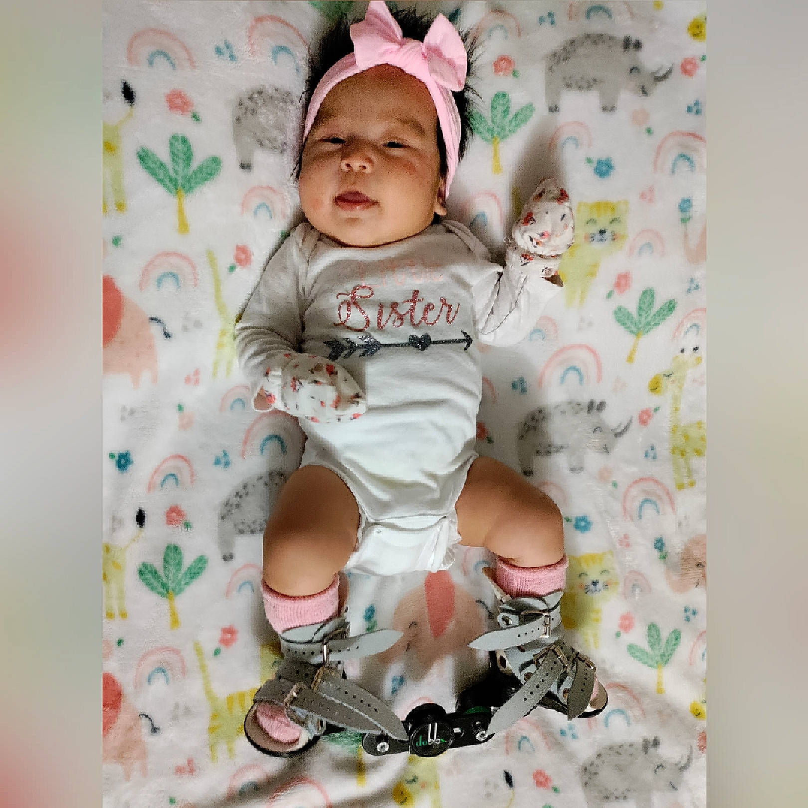 Rosanette is registered to the contest to win money with this photo: baby, baby_products, baby_sleeping, baby_toddler_clothing, cap, child, comfort, face, font, happy, headwear, linens, pattern, person, pink, product, sitting, sleeve, sock, t_shirt