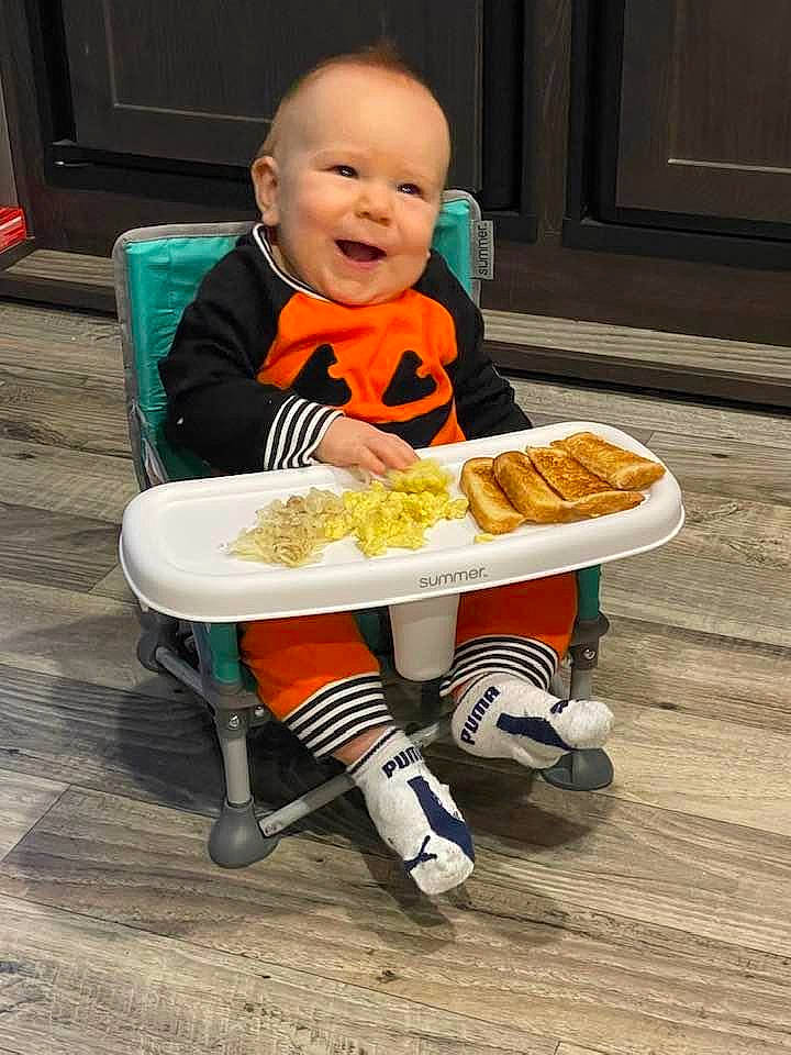 Tristan joined the competition — help win amazing prizes! baby, baby_food, baby_toddler_clothing, biting, chair, child, comfort_food, cuisine, dish, eating, flooring, food, food_craving, junk_food, orange, person, sitting, smile, t_shirt, tableware